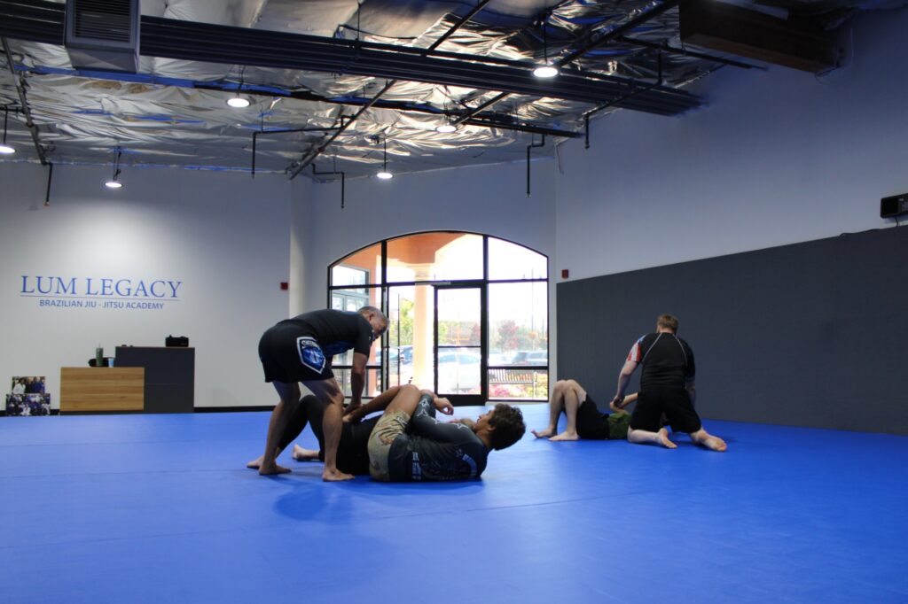 bjj coach teaching students on mats